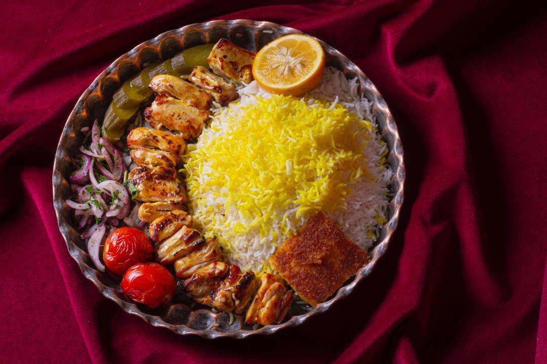 Joojeh Kabab with saffron rice, grilled tomatoes and tahdig