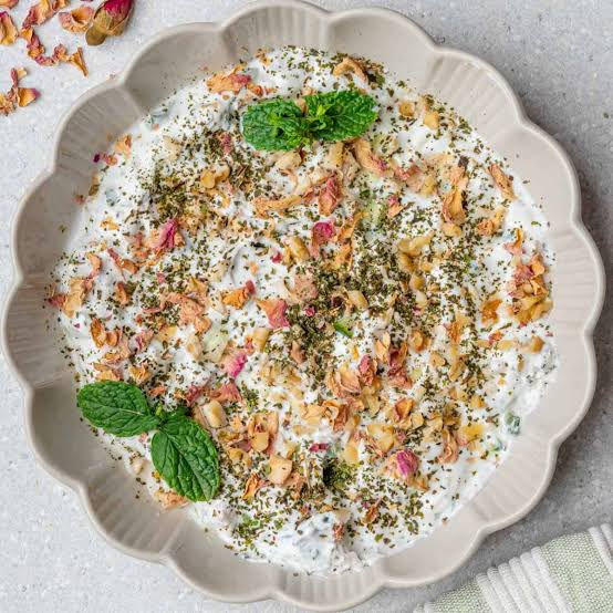 Mast-o Khiar garnished with walnuts, dried mint, rose petals and fresh mint