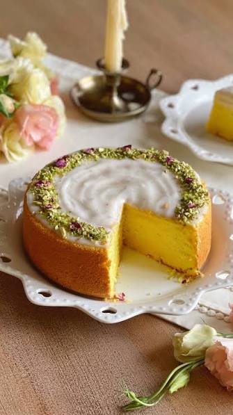Persian Love Cake decorated with pistachios and rose petals